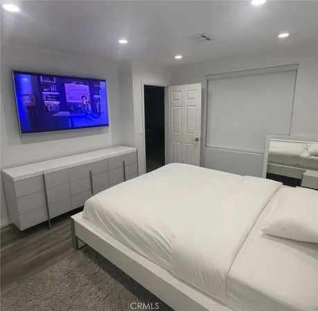 a bedroom with a bed and a dresser