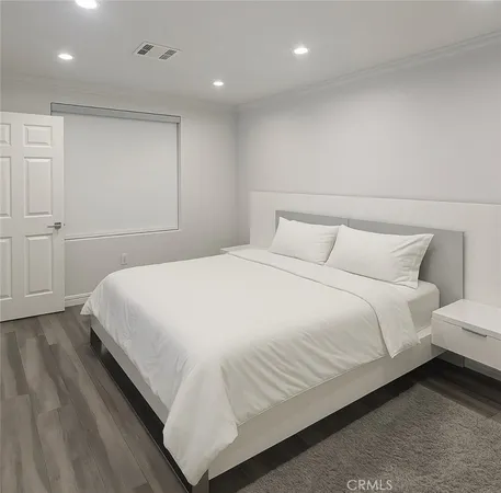 a bedroom with a bed and a night stand