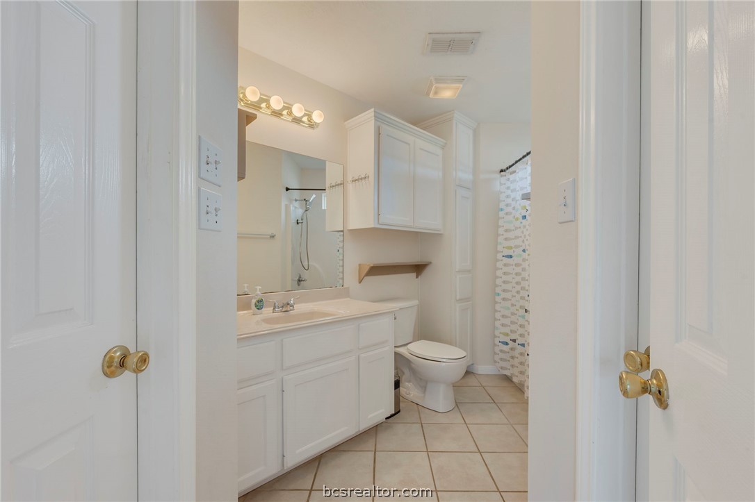 501 Riggs Street Brenham, TX 77833 - Photo 11 of 20 a bathroom with a sink a toilet and shower