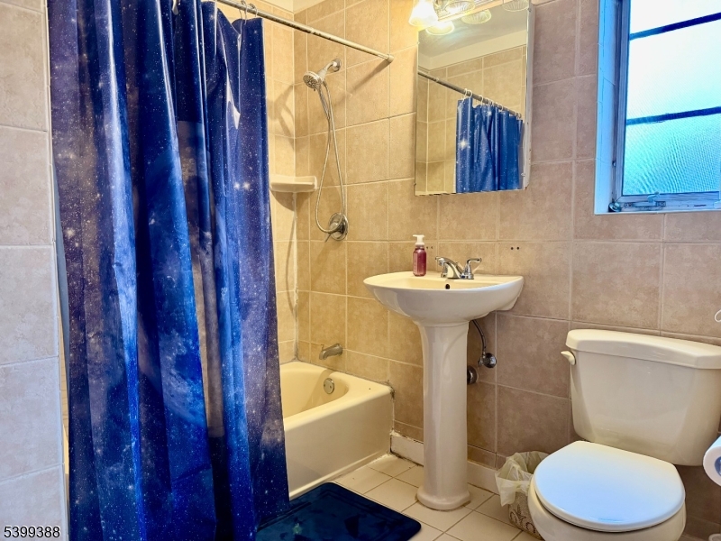 80 Troy Drive Springfield, NJ 07081 - Photo 6 of 11 a bathroom with a sink toilet a mirror and bathtub