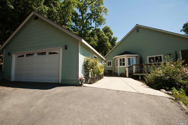 3315 Old River Road Ukiah, CA 95482 - Photo 1 of 1 a front view of a house with a yard and garage