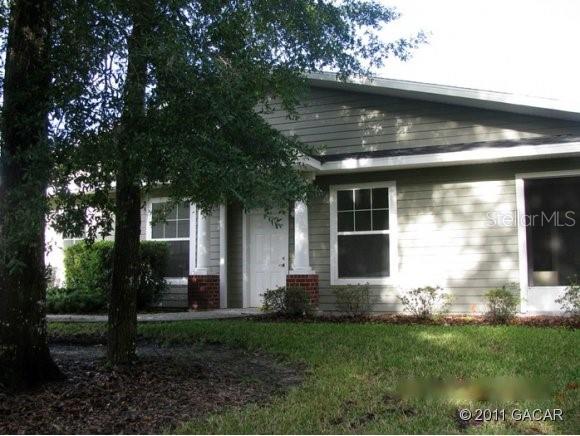 1609 Northwest 29 Road, Unit B108 Gainesville, FL 32605 - Photo 1 of 1 a front view of a house with a yard