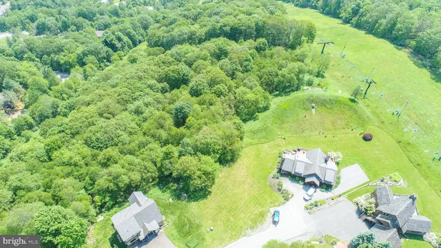 an aerial view of a house with a yard