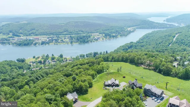 an aerial view of a houses with a lake view