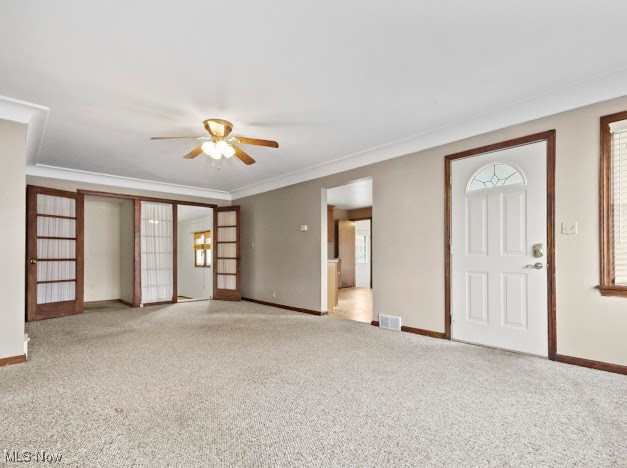 284 Wilson Street Struthers, OH 44471 - Photo 6 of 16 Unfurnished living room featuring carpet floors, ceiling fan, and crown molding