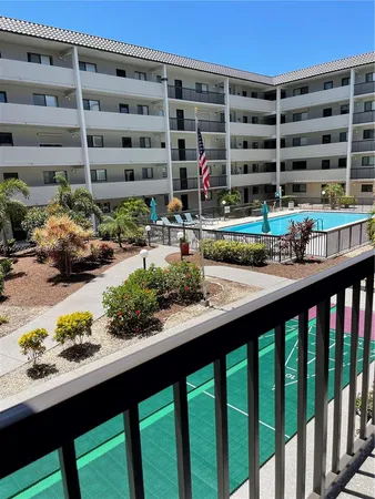 a roof deck with table and chairs and potted plants