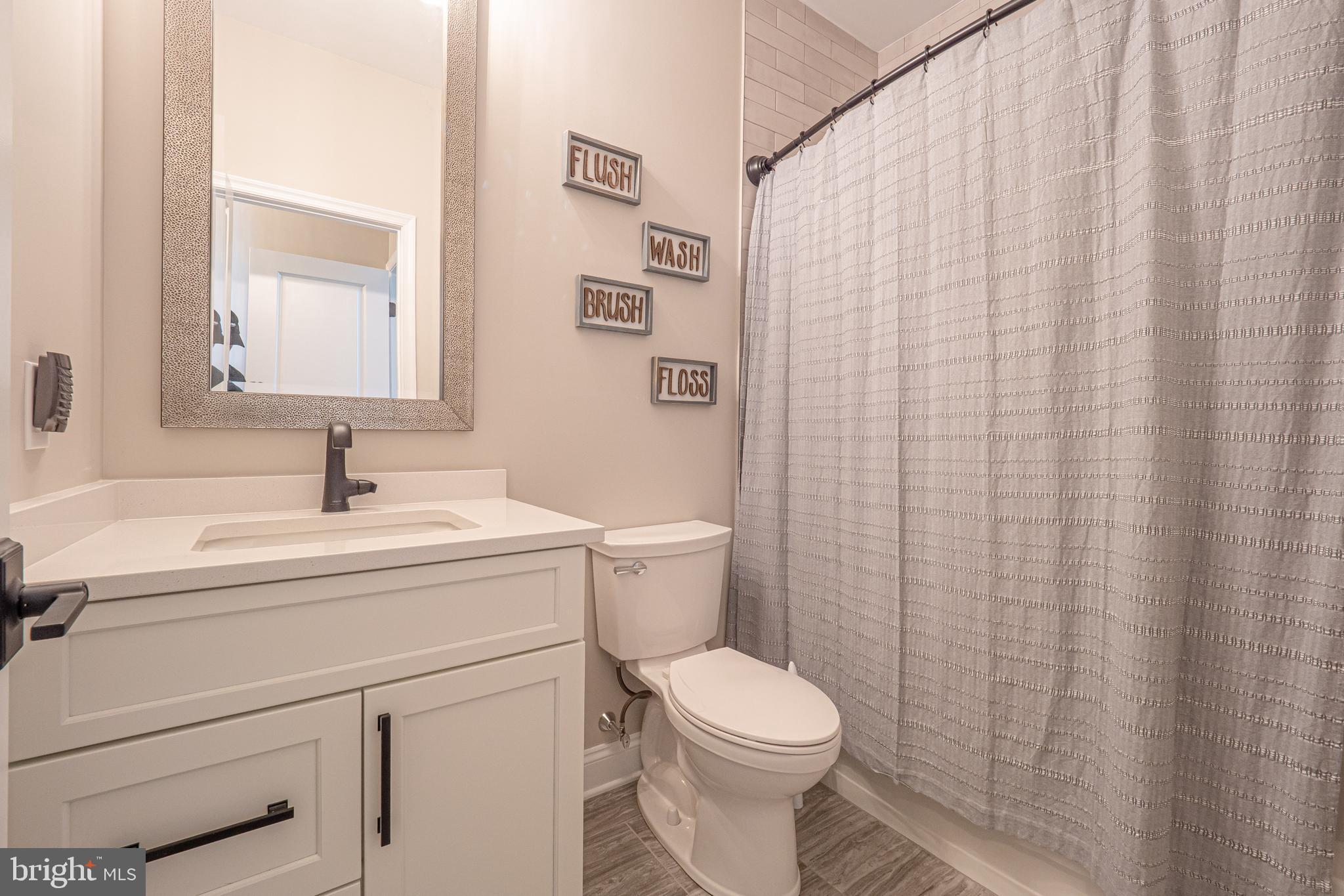8 Timber Mill Lane, Unit TAGLIO Landenberg, PA 19350 - Photo 36 of 42 a bathroom with a sink a toilet and a mirror