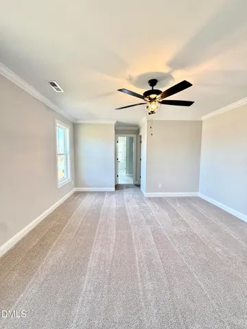 a view of a room with a ceiling fan