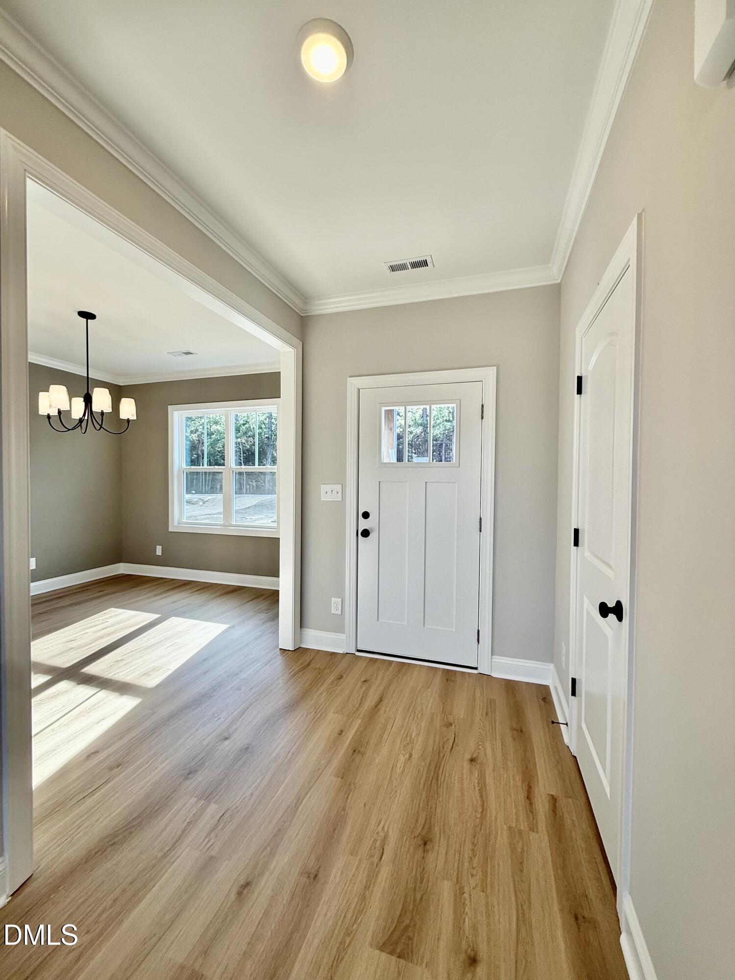 6862 Fire Tower Road Spring Hope, NC 27882 - Photo 2 of 35 a view of an empty room with wooden floor and a window