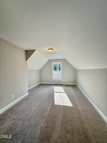 a view of a room with wooden floor and white walls