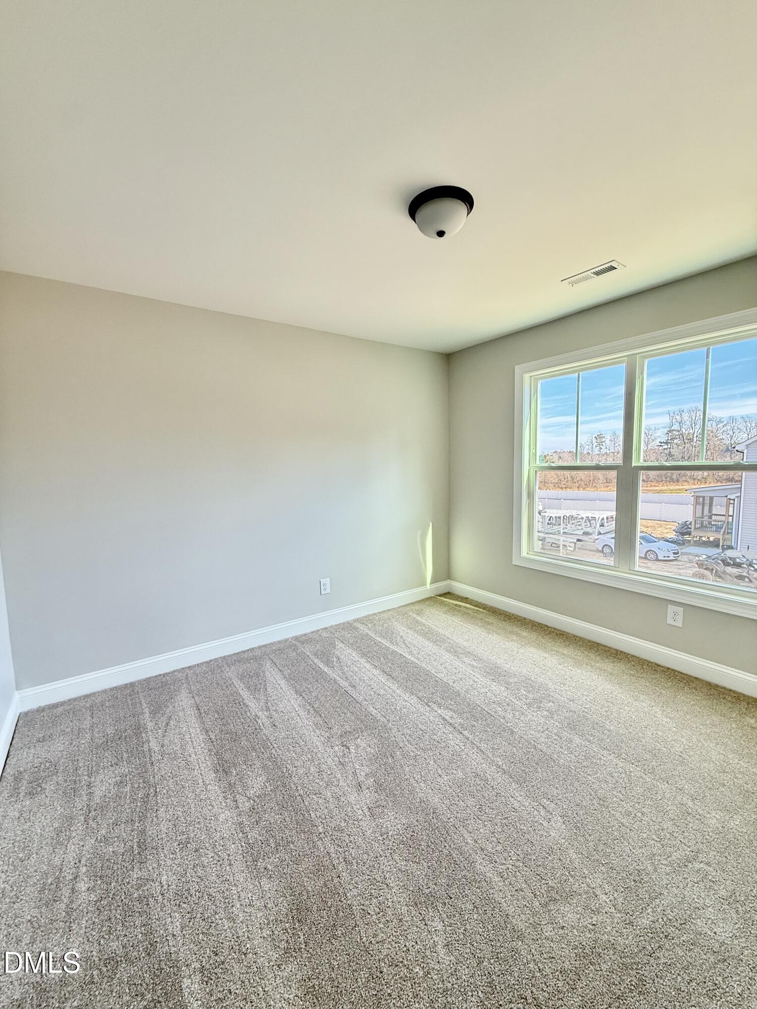 6862 Fire Tower Road Spring Hope, NC 27882 - Photo 30 of 35 an empty room with a fireplace and windows