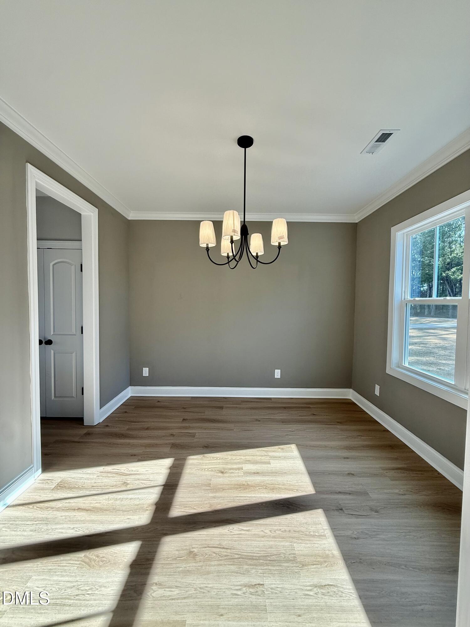 6862 Fire Tower Road Spring Hope, NC 27882 - Photo 5 of 35 a view of an empty room with wooden floor and a window
