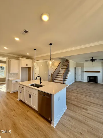 a kitchen with stainless steel appliances granite countertop a sink and stove