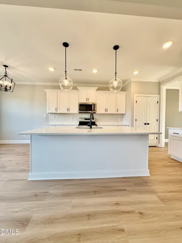 a view of kitchen with wooden floor and window