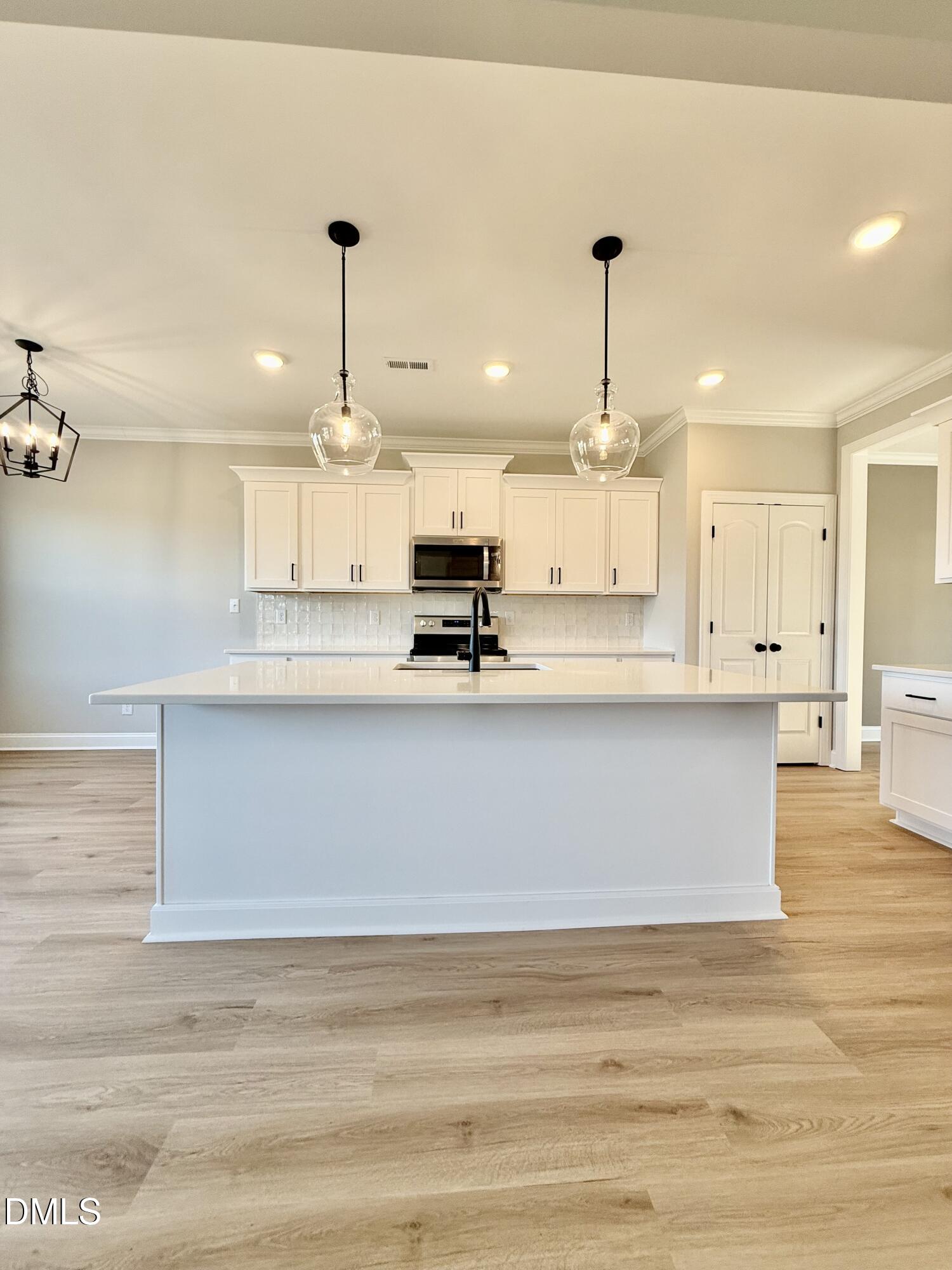 6862 Fire Tower Road Spring Hope, NC 27882 - Photo 9 of 35 a view of kitchen with wooden floor and window