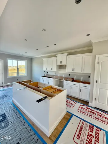 a large white kitchen with a stove a sink and a refrigerator