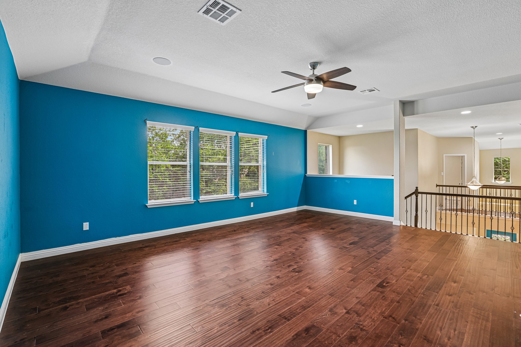 1924 Granite Springs Road Leander, TX 78641 - Photo 22 of 36 Rich hardwood floors complement this versatile bonus room, offering natural illumination and an open layout.