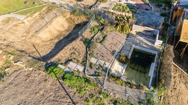 an aerial view of a houses with backyard