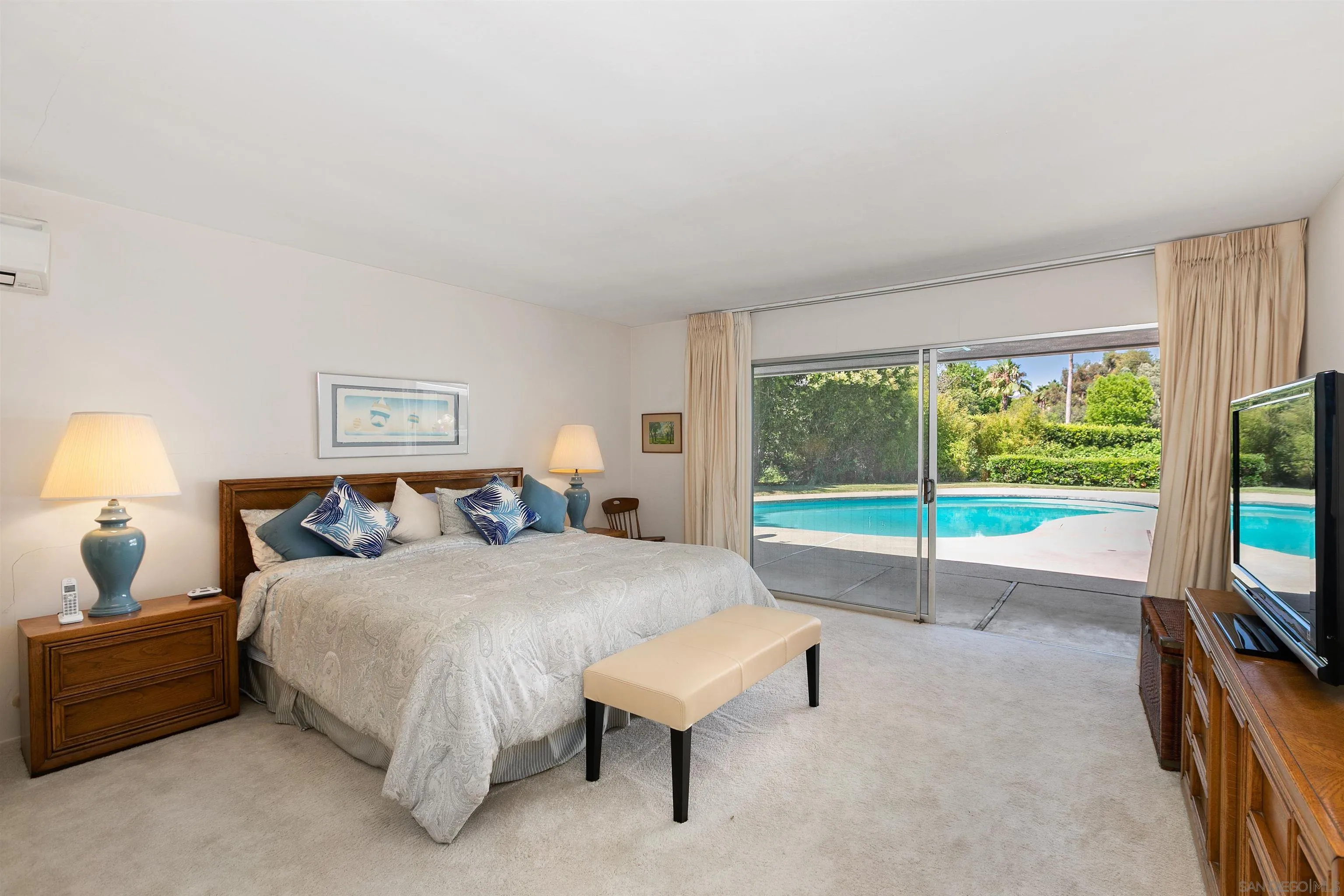 6350 Mimulus Rancho Santa Fe, CA 92067 - Photo 12 of 21 a bedroom with a bed flat screen tv and a large window