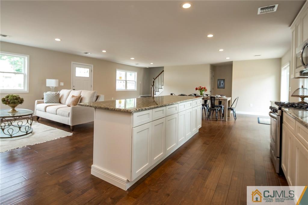 44 Caldwell Road Edison, NJ 08817 - Photo 13 of 25 a large white kitchen with lots of counter top space and furniture