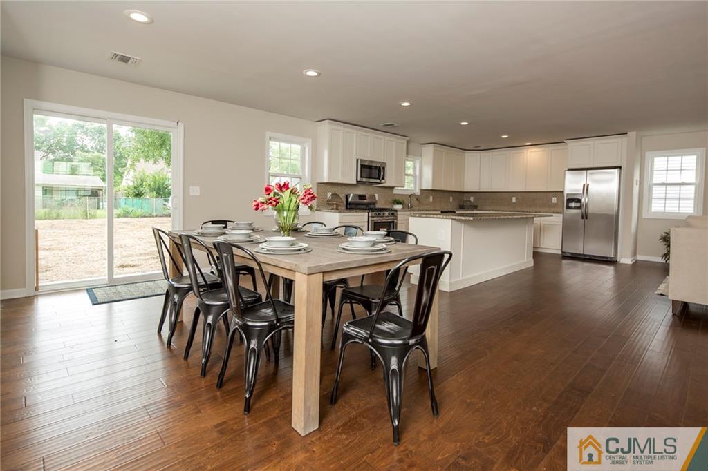44 Caldwell Road Edison, NJ 08817 - Photo 15 of 25 a dining room with furniture and wooden floor