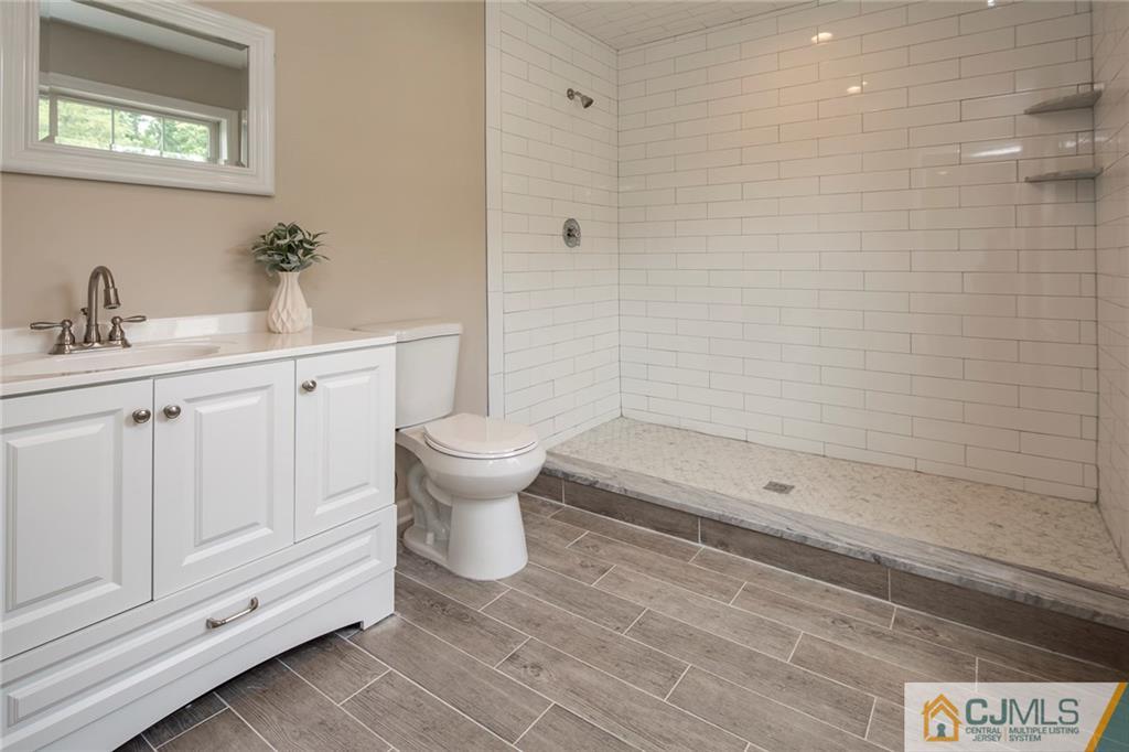 44 Caldwell Road Edison, NJ 08817 - Photo 23 of 25 a bathroom with a sink a toilet and shower