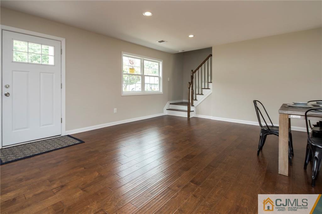 44 Caldwell Road Edison, NJ 08817 - Photo 4 of 25 a view of an empty room with wooden floor and a window