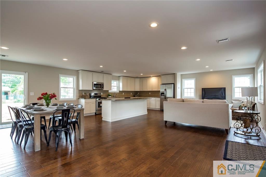 44 Caldwell Road Edison, NJ 08817 - Photo 5 of 25 a living room with furniture a wooden floor and a kitchen view