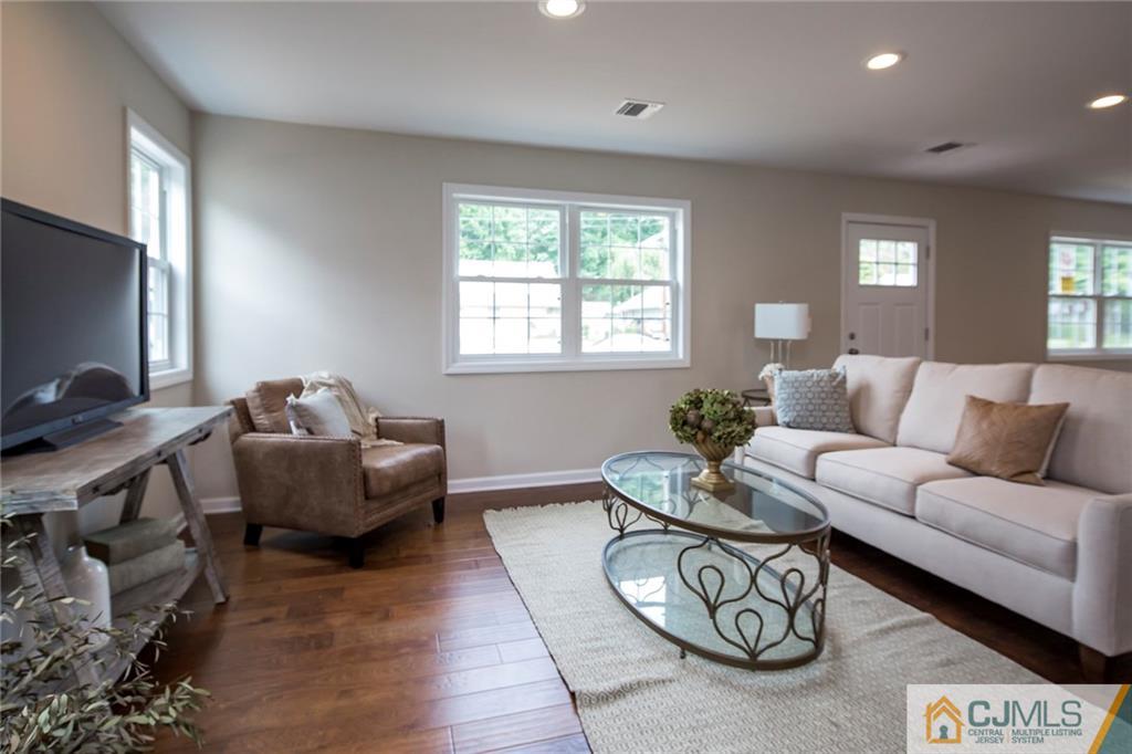 44 Caldwell Road Edison, NJ 08817 - Photo 8 of 25 a living room with furniture a window and a flat screen tv