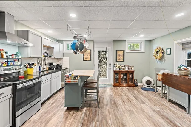 a kitchen with granite countertop lots of counter top space and wooden floors