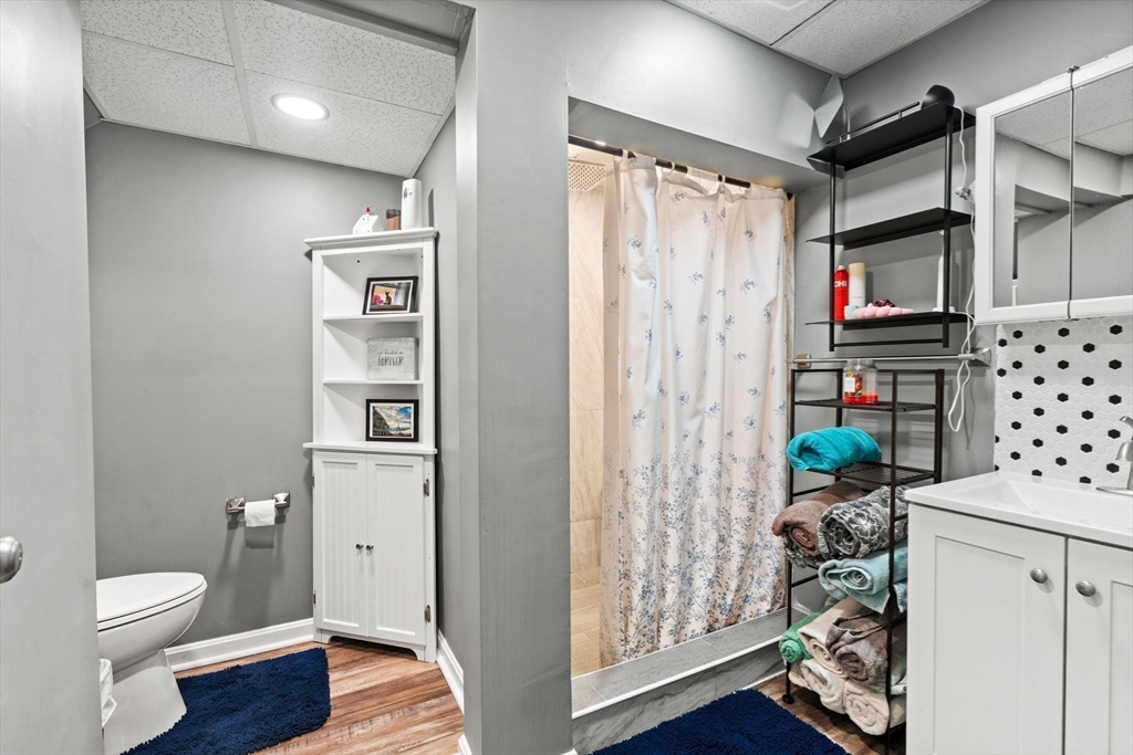 46-48 Walnut Street Peabody, MA 01960 - Photo 16 of 25 a bathroom with a toilet a sink and shower
