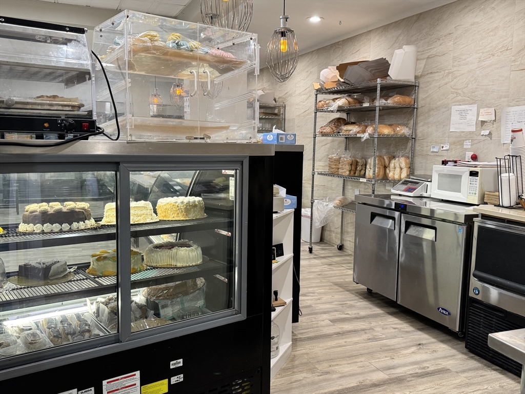 46-48 Walnut Street Peabody, MA 01960 - Photo 24 of 25 a kitchen with stainless steel appliances granite countertop a stove and a refrigerator