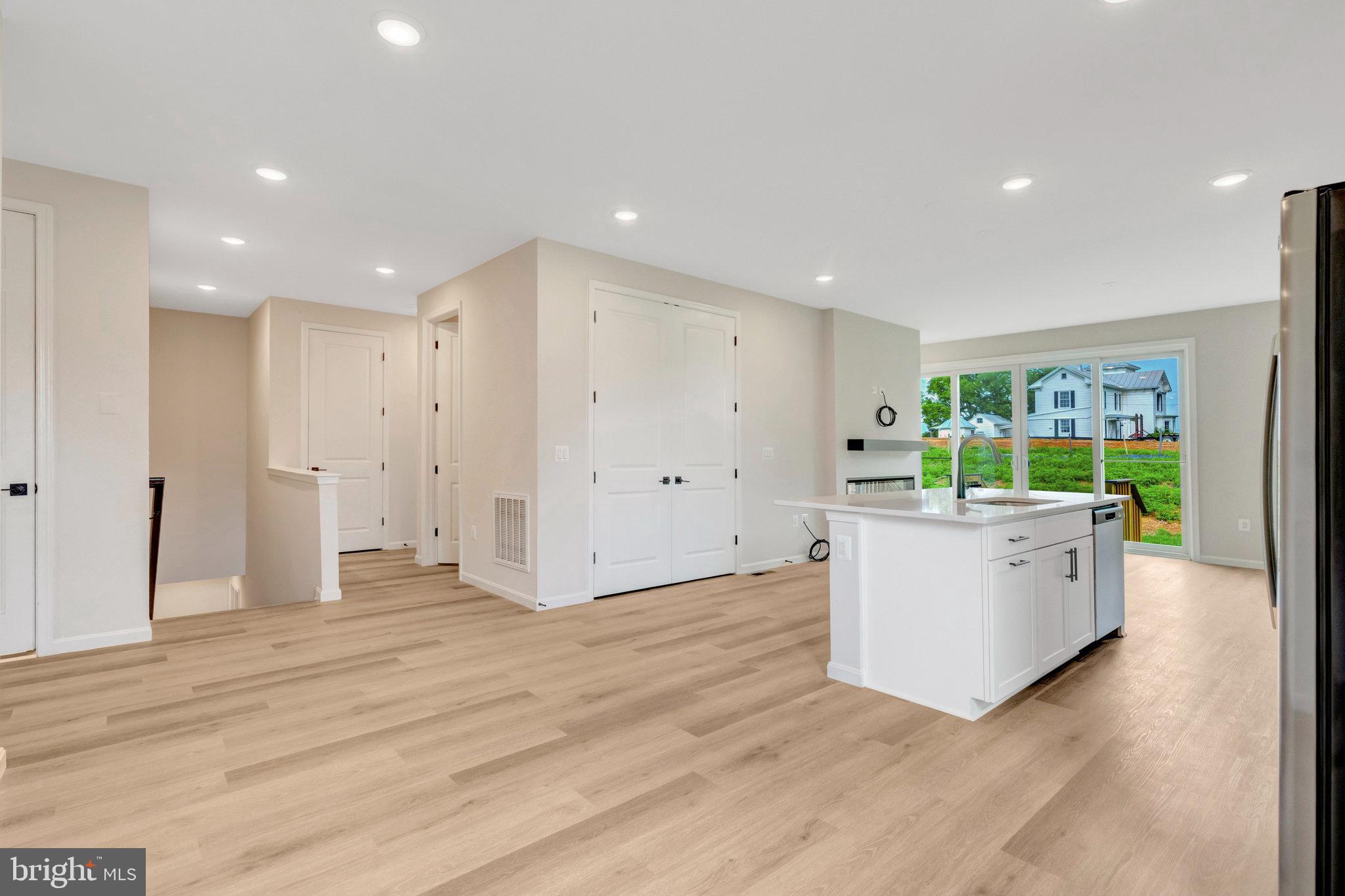 100 Midsummer Lane Middletown, VA 22645 - Photo 13 of 47 a large white room with a large window and furniture