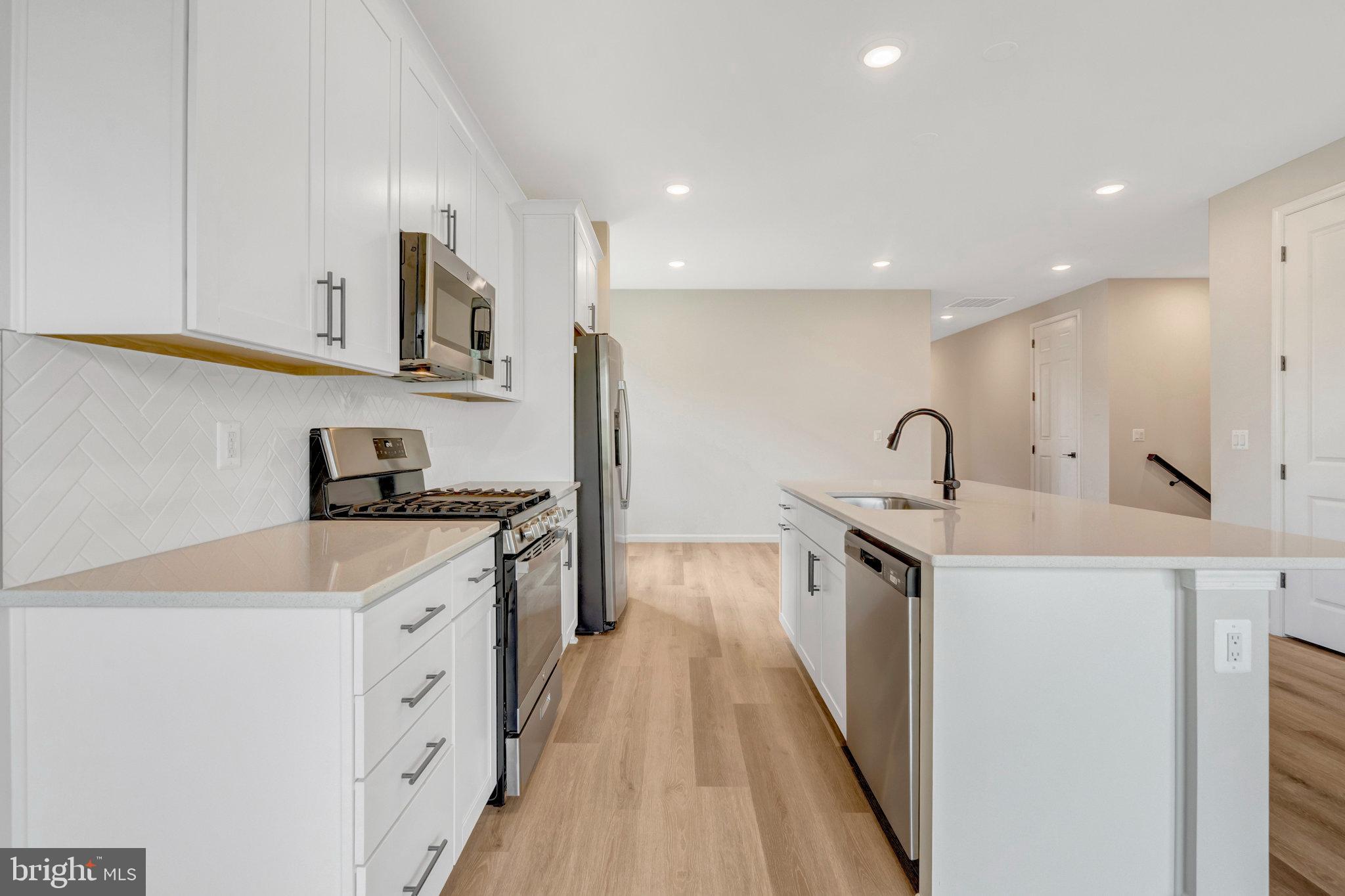 100 Midsummer Lane Middletown, VA 22645 - Photo 17 of 47 a kitchen with stainless steel appliances a sink stove and cabinets