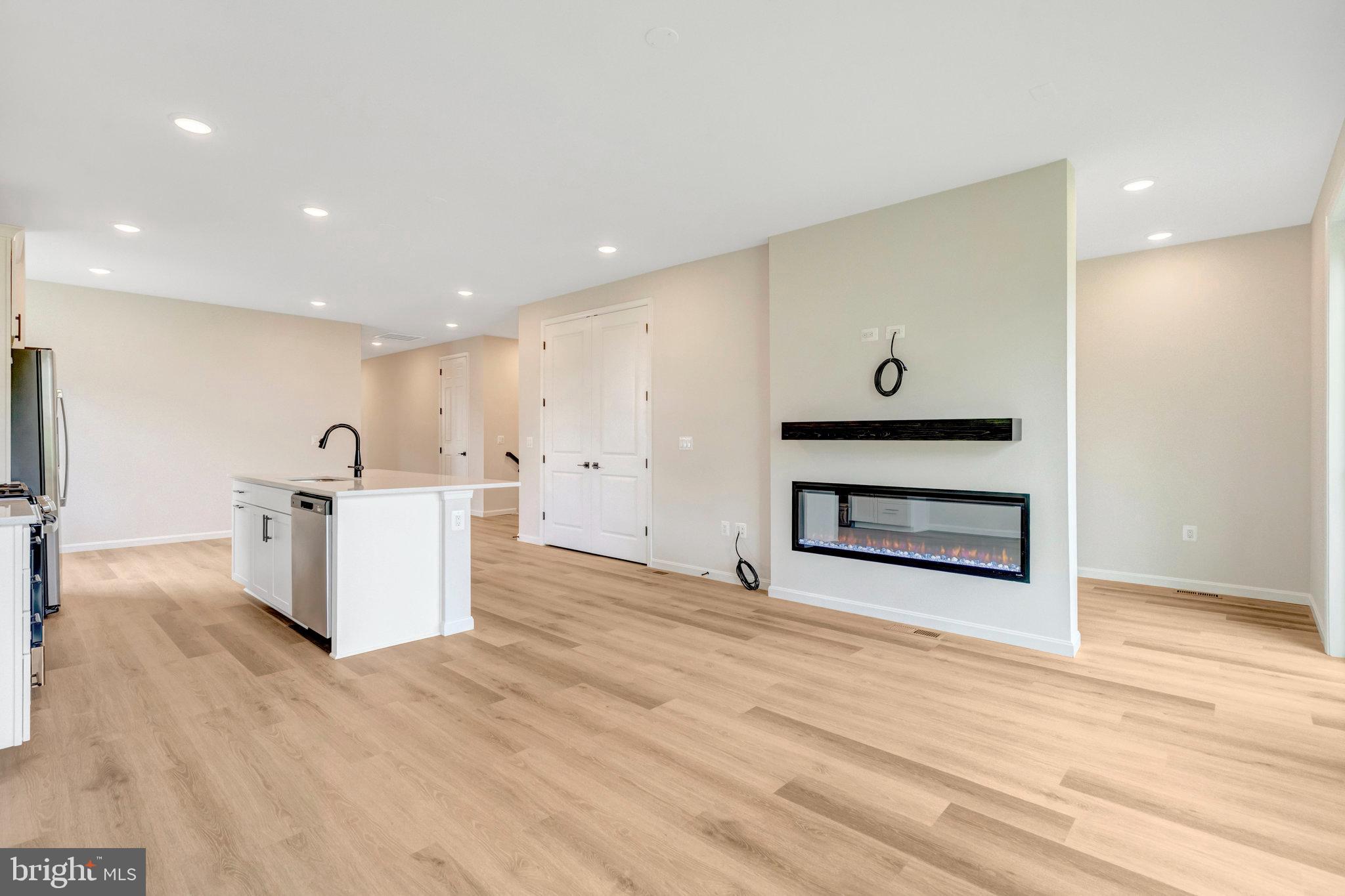 100 Midsummer Lane Middletown, VA 22645 - Photo 19 of 47 a view of a kitchen with a sink a fireplace and wooden floor
