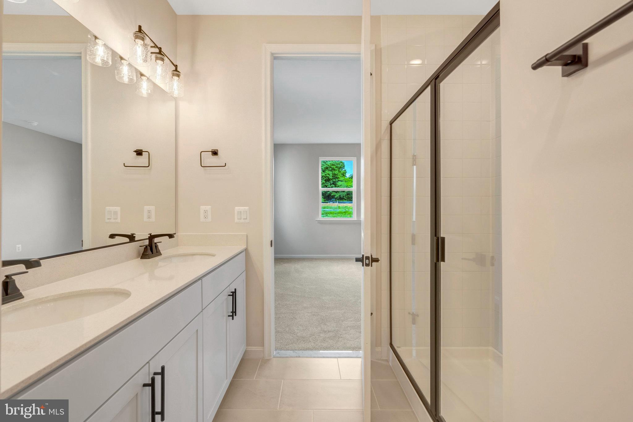 100 Midsummer Lane Middletown, VA 22645 - Photo 32 of 47 a bathroom with a granite countertop sink a mirror and a shower
