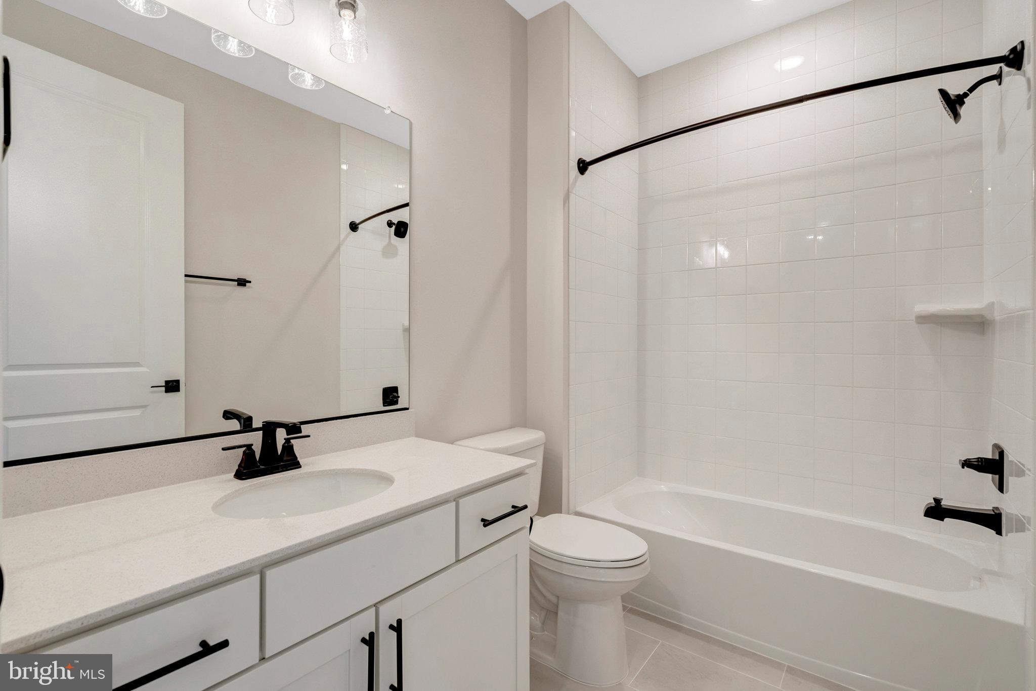 100 Midsummer Lane Middletown, VA 22645 - Photo 10 of 47 a bathroom with a sink a toilet a shower and a mirror