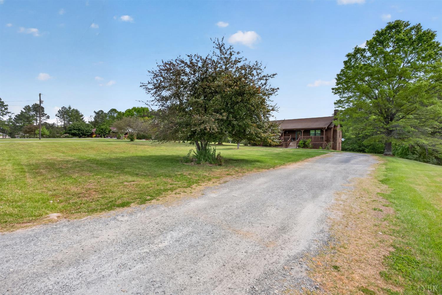 1002 Homeplace Road Rustburg, VA 24588 - Photo 36 of 48 a view of a house with a yard and a large tree