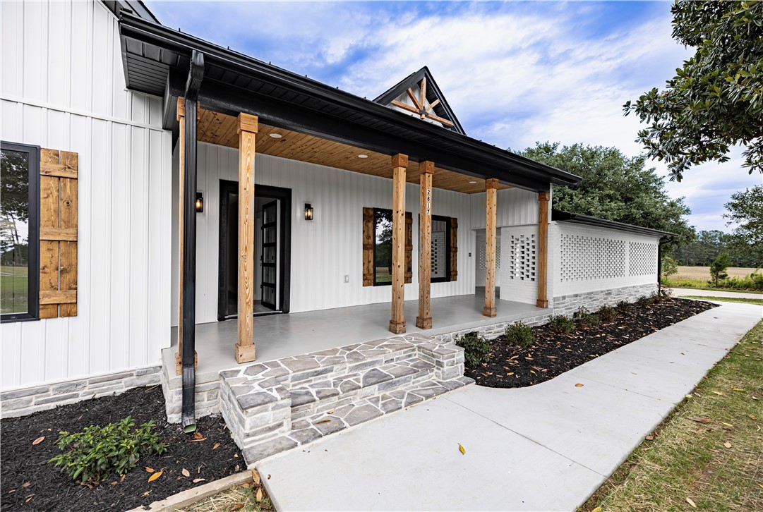 2817 Broadway Lake Road Anderson, SC 29621 - Photo 3 of 41 A welcoming front entrance featuring rustic wooden columns and stylish board and batten siding.