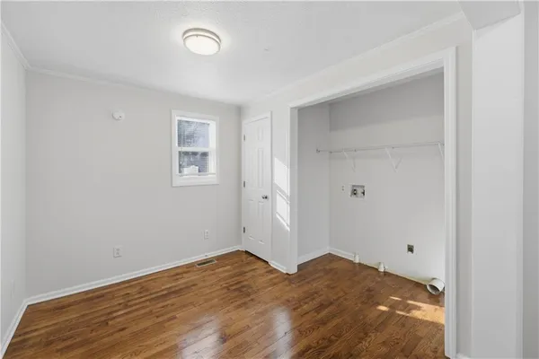 a view of a room with wooden floor and window
