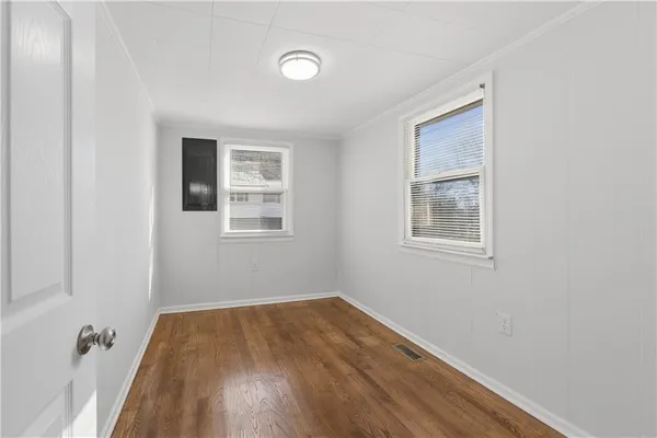 a view of a room with wooden floor and windows