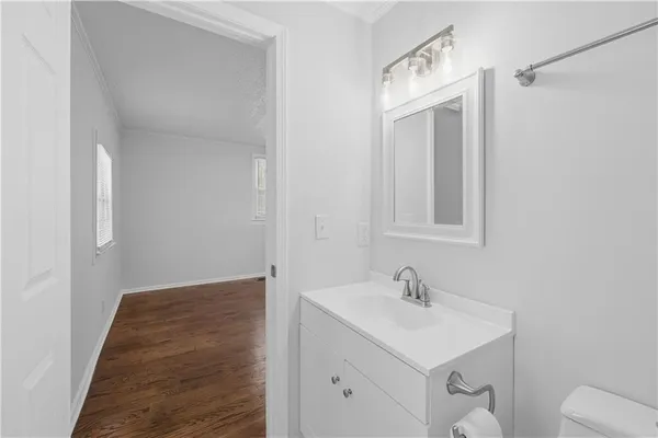 a bathroom with a sink a toilet and a mirror