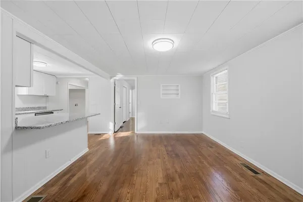 a view of a kitchen with wooden floor