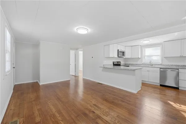 a view of kitchen with wooden floor