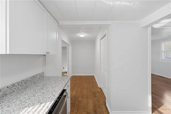 a kitchen with granite countertop a sink and a refrigerator