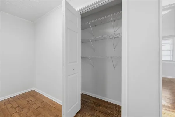 a view of walk in closet with empty room