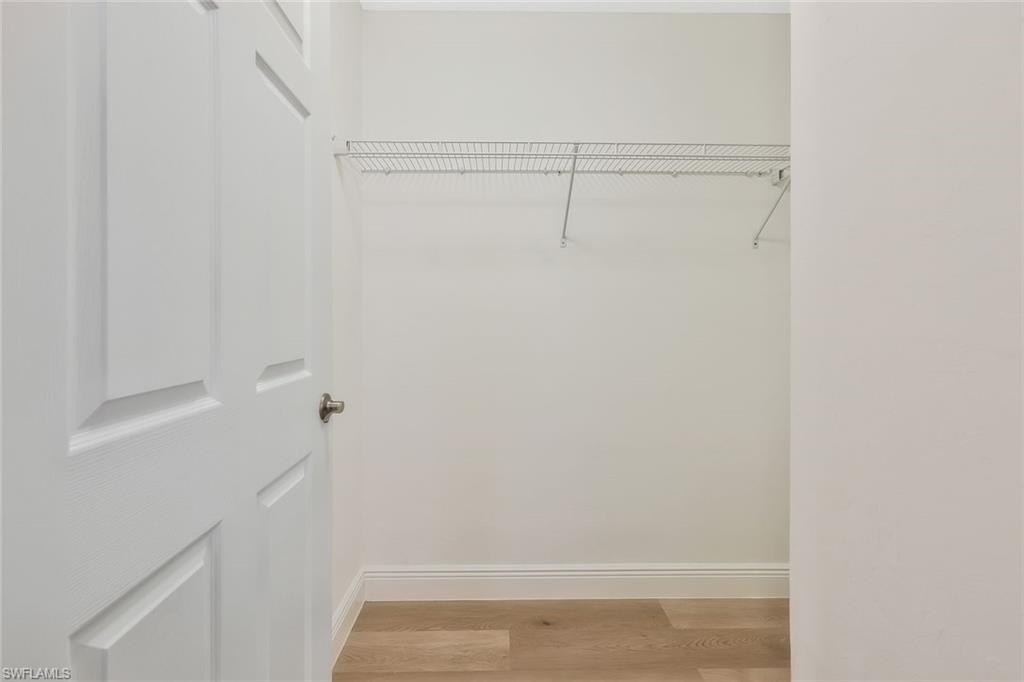 18225 Creekside Preserve Loop, Unit 102 Fort Myers, FL 33908 - Photo 16 of 25 Walk in closet with light wood-style floors