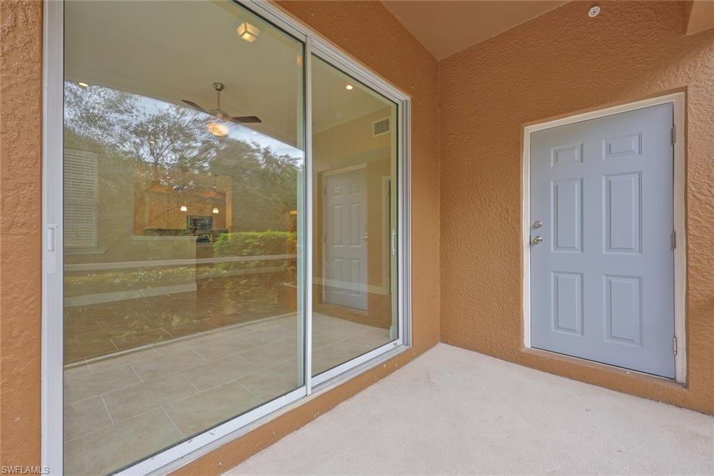18225 Creekside Preserve Loop, Unit 102 Fort Myers, FL 33908 - Photo 22 of 25 View of exterior entry featuring stucco siding