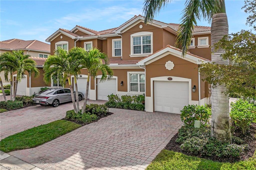 18225 Creekside Preserve Loop, Unit 102 Fort Myers, FL 33908 - Photo 24 of 25 Mediterranean / spanish-style home with a tiled roof, decorative driveway, stucco siding, and a garage