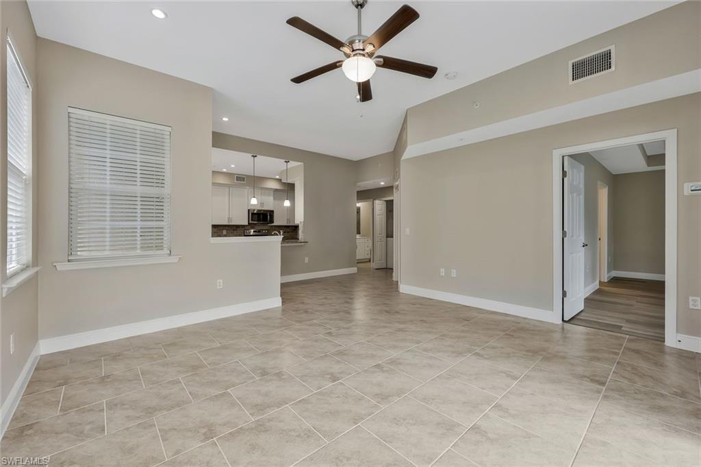 18225 Creekside Preserve Loop, Unit 102 Fort Myers, FL 33908 - Photo 5 of 25 Unfurnished living room featuring ceiling fan, recessed lighting, and light tile patterned floors